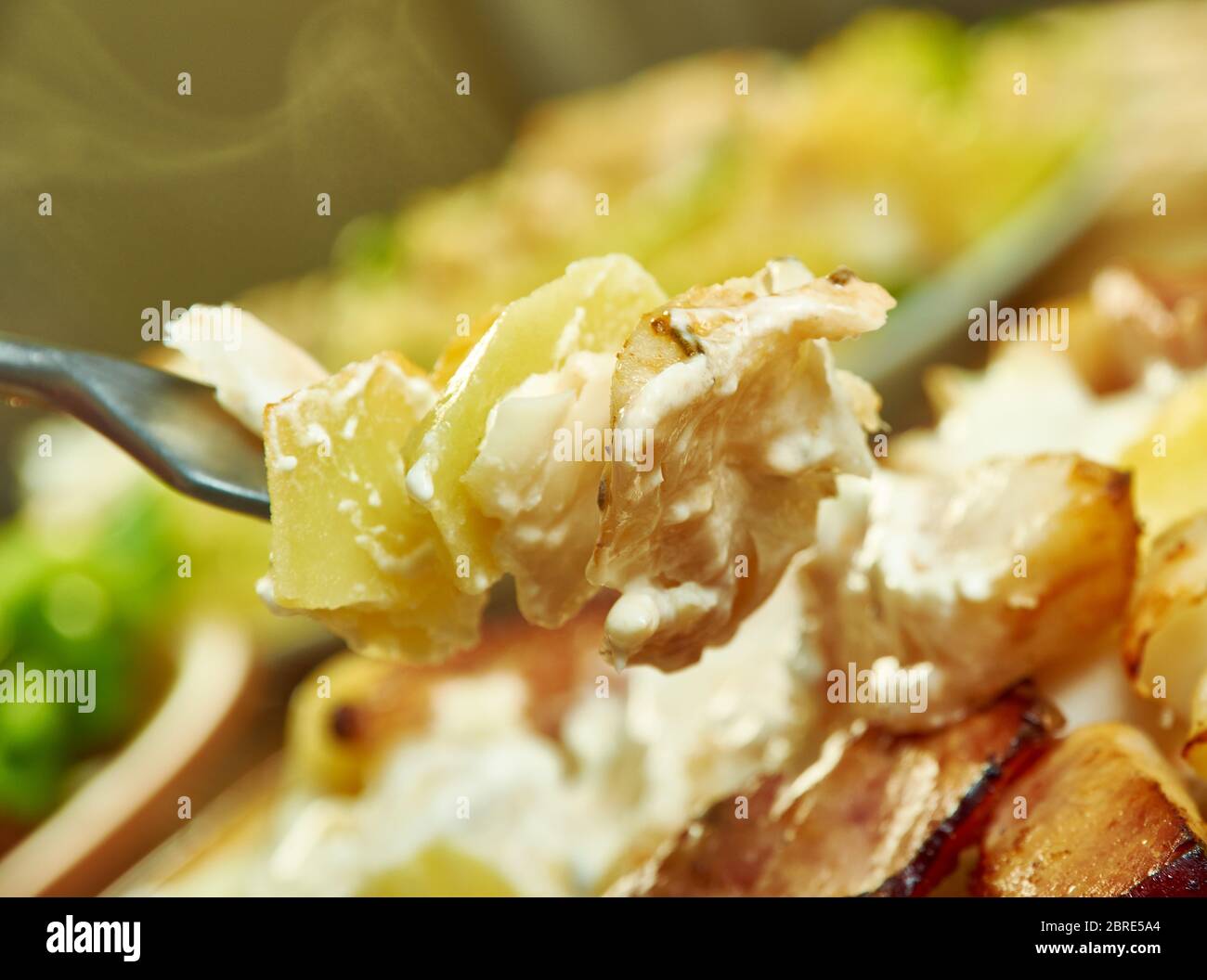 Smoked haddock savoy cabbage,bacon and creamy potato gratin Stock Photo Alamy