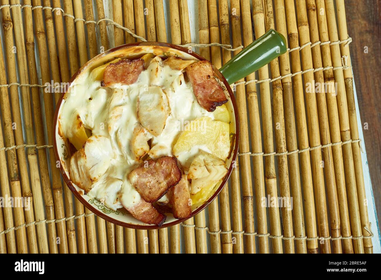 Smoked haddock savoy cabbage,bacon and creamy potato gratin Stock Photo