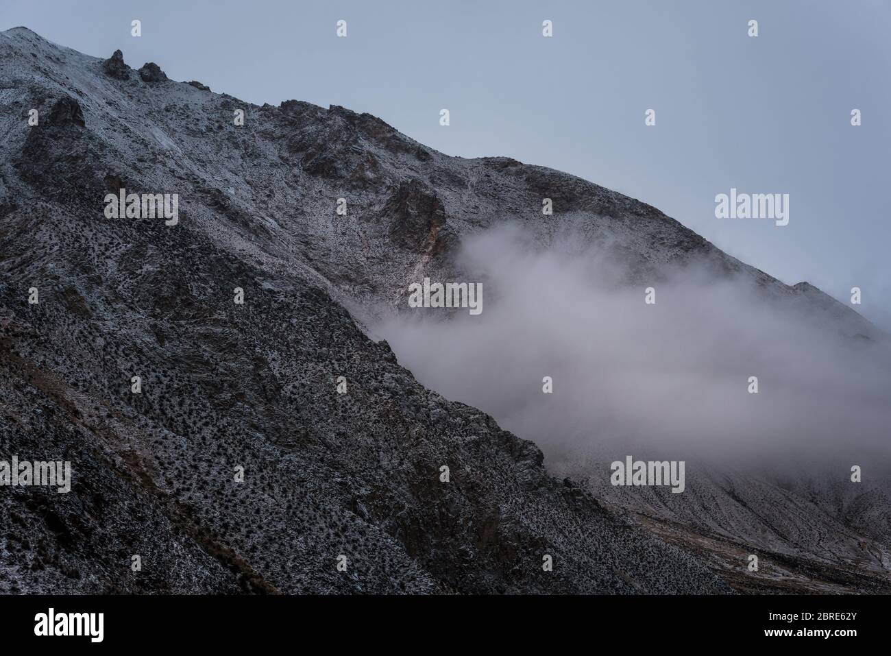 View of snow mountain surrounded by clouds with morning fog Stock Photo