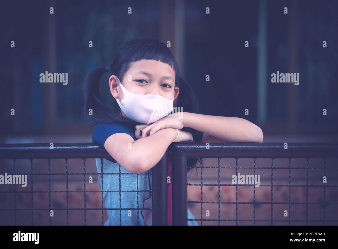 Portrait asian little child girl wearing  face mask stay at home during covid-19 lock down. Stock Photo