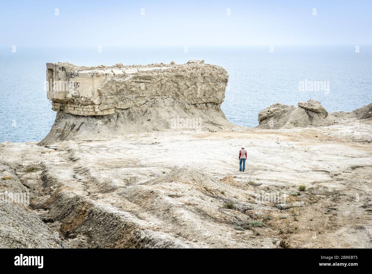 Excavated fortifications from the Second World War in Feodosia, Crimea, Russia. Traveler walks among the ruins on the deserted Crimea coast. The post Stock Photo