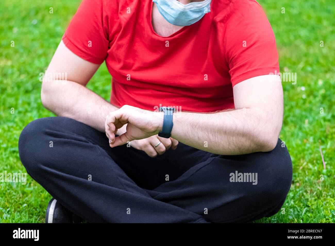 Man wearing face mask watching the smart watch after exercises Stock ...