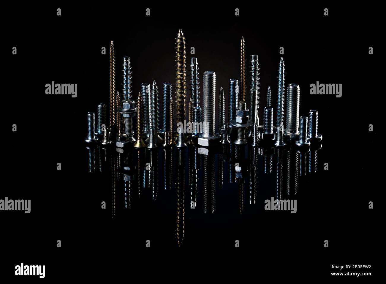 The city at night from small screws and bolts. Advertising photo of materials and products for construction. Stock Photo