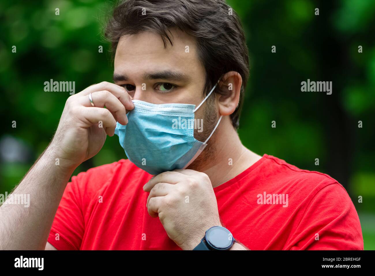 Man wearing surgical mask while he is outside Stock Photo Alamy