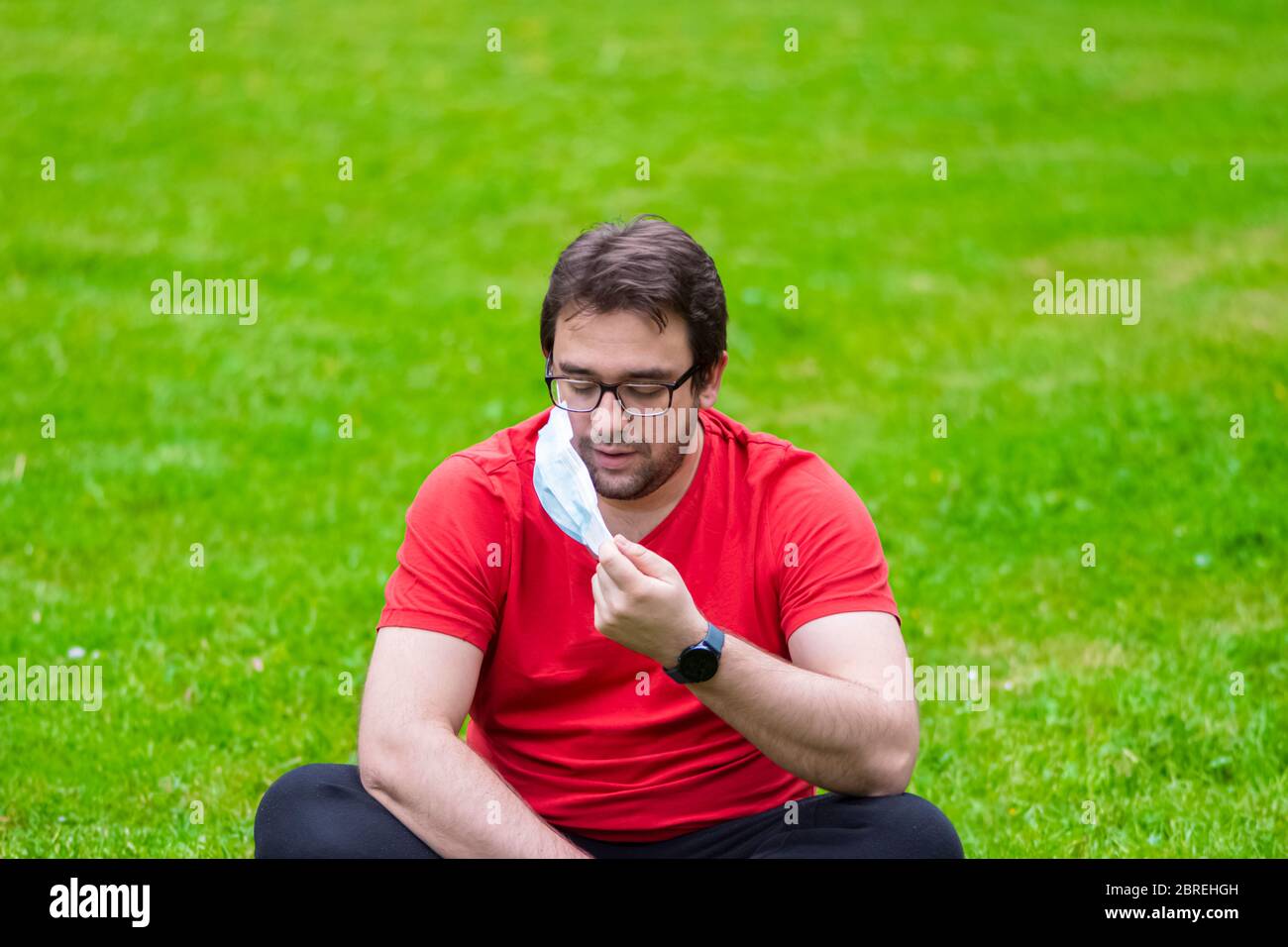 Man wearing surgical mask while he is outside Stock Photo - Alamy