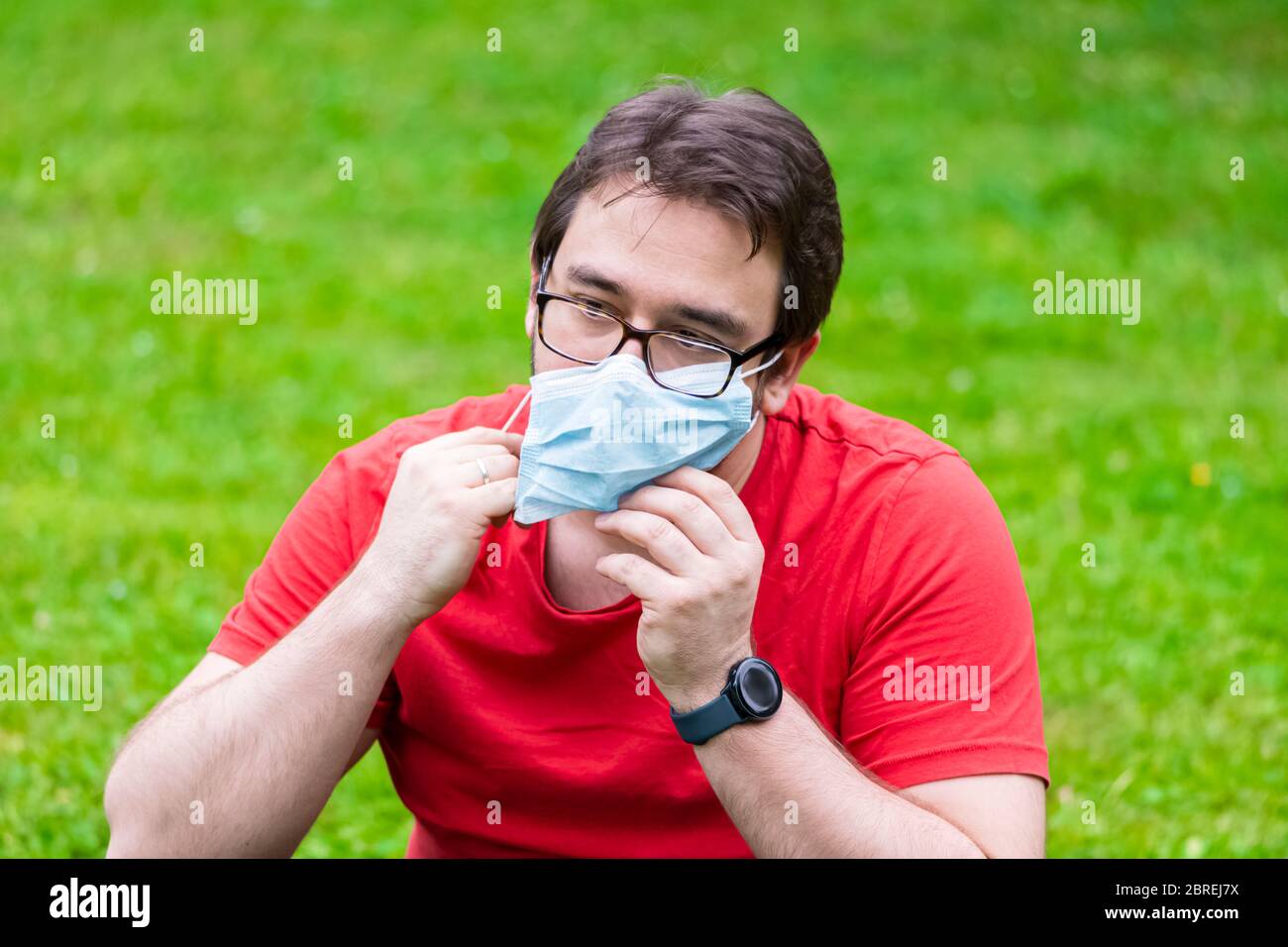 Man wearing surgical mask while he is outside Stock Photo - Alamy