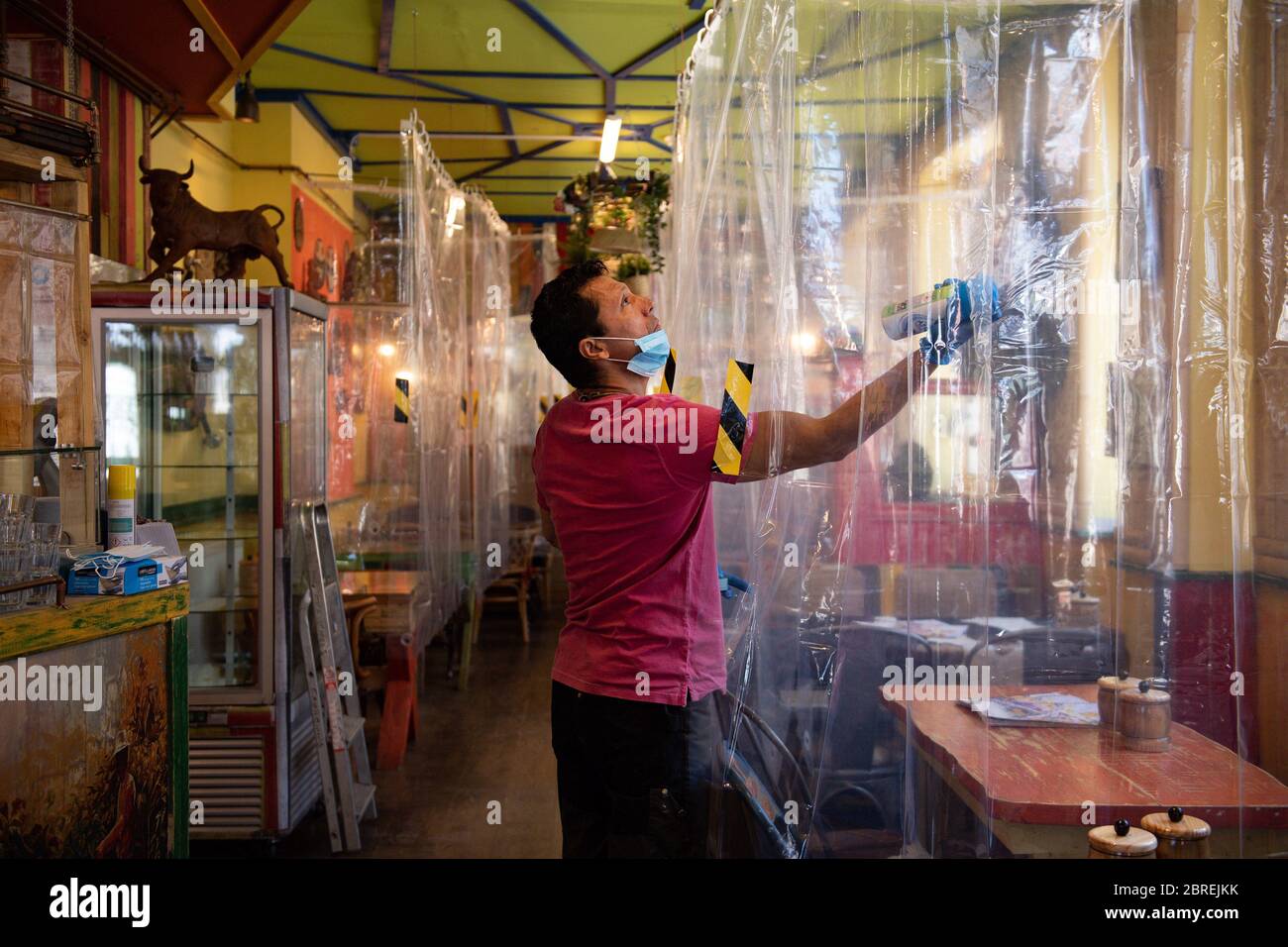 Cafe owner Francini Osorio who has installed an air purifier and 35 clear shower curtains, which will divide customers and tables, in the Francini Cafe De Colombia, Worcester, ready for the re-opening of his business as lockdown restrictions are eased. Stock Photo