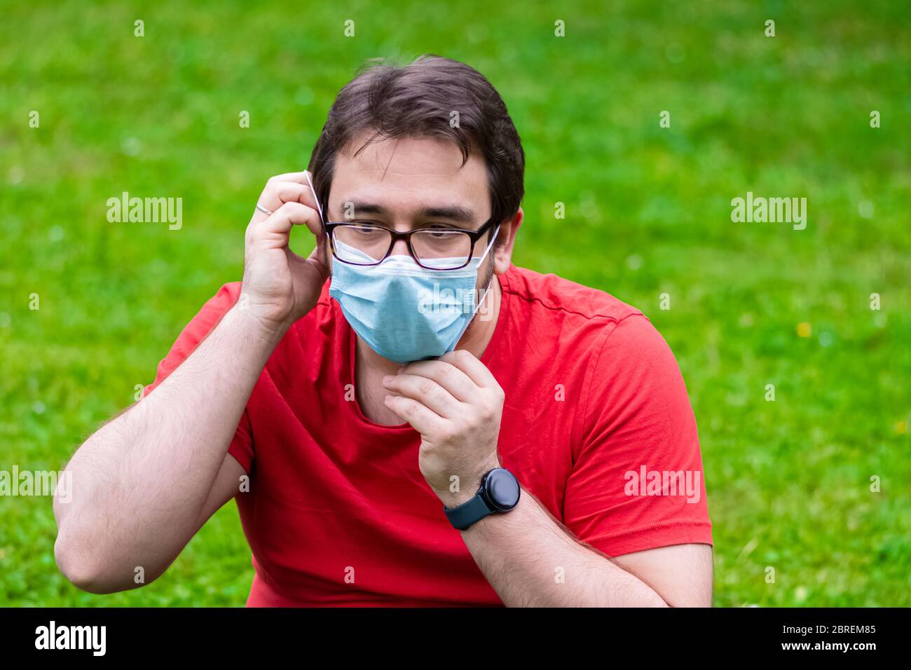 Man wearing surgical mask while he is outside Stock Photo - Alamy