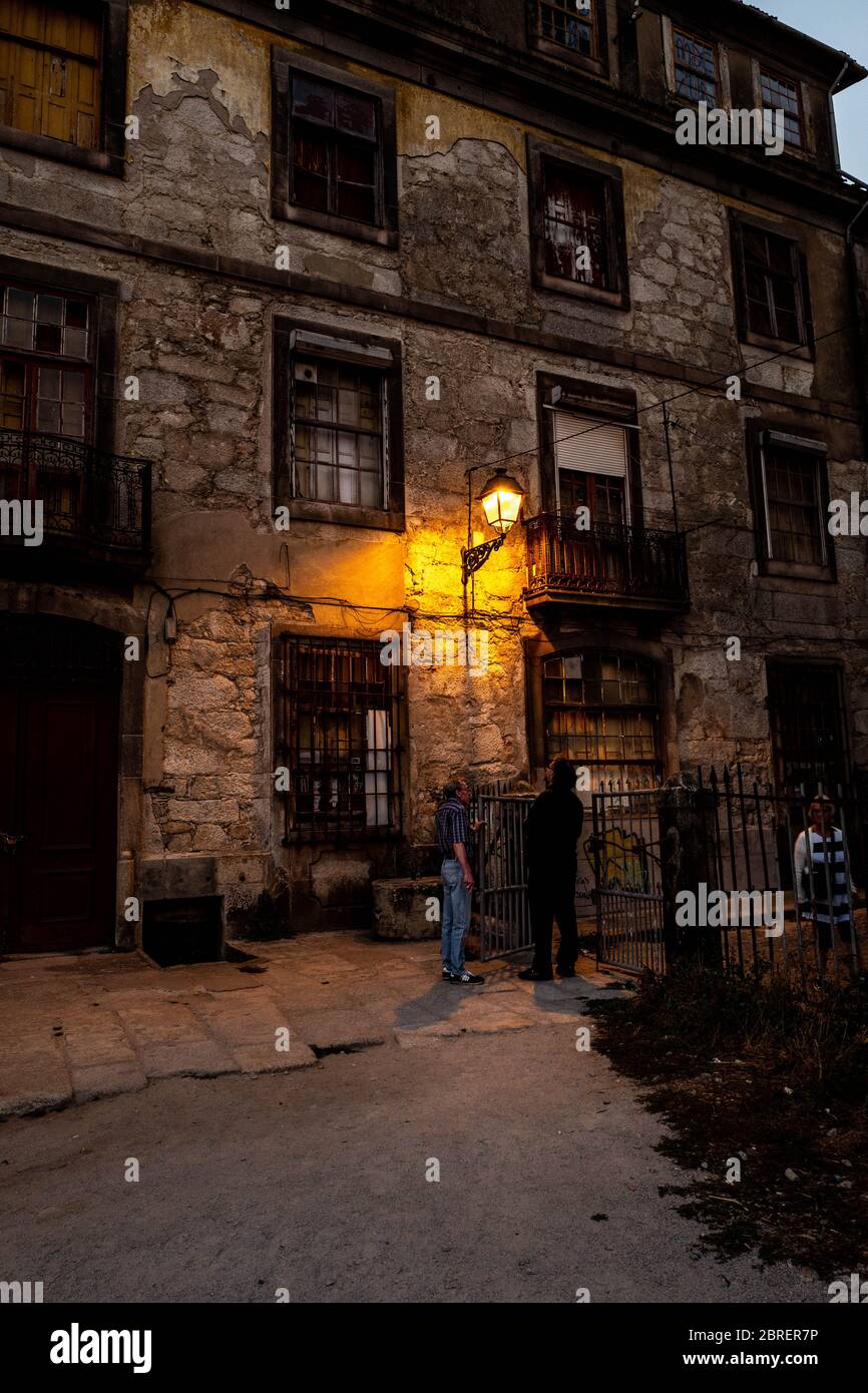 Old ruined building in the old Porto at nightfall with a lamppost. Stock Photo