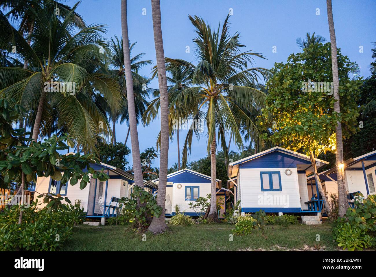 house on the beach near palm trees with a view of the sandy beach Stock Photo