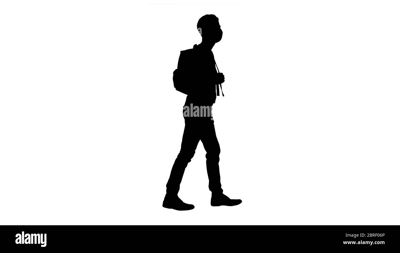 Silhouette Student in protective masks walking with backpack. Stock Photo