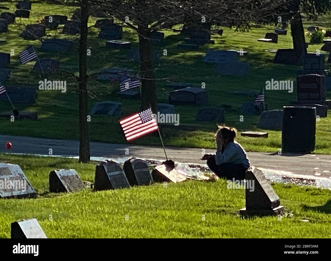 Racine, Wisconsin, USA. 20th May, 2020. A woman stops to honor her