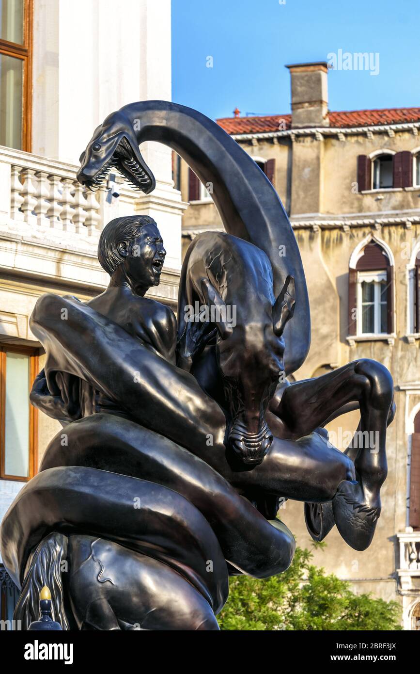 Venice, Italy - May 18, 2017: Sculpture by Damien Hirst outside the Palazzo Grassi in Venice. Giant snake wraps around the rider. Modern art in Venice Stock Photo