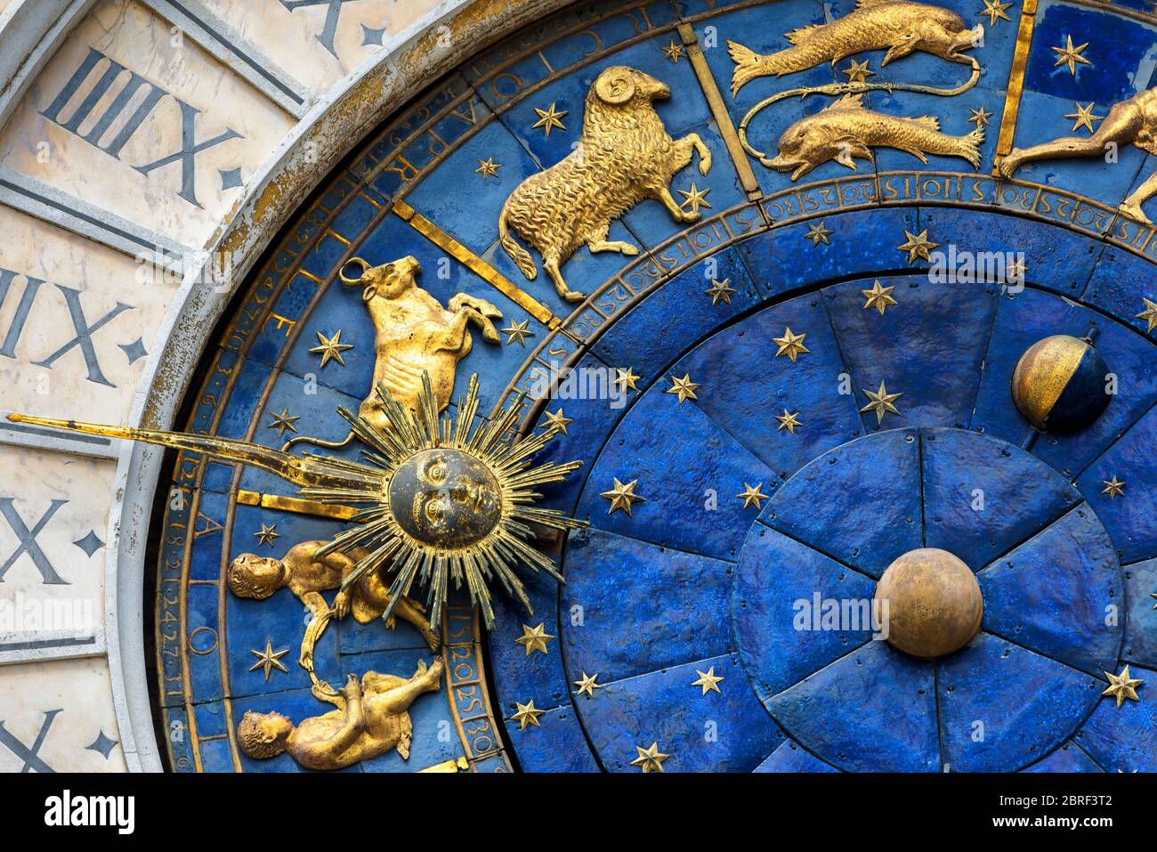 Ancient clock (Torre dell'Orologio) in the St. Mark's Square in Venice, Italy. Detail with ckock face and Zodiac signs. Stock Photo