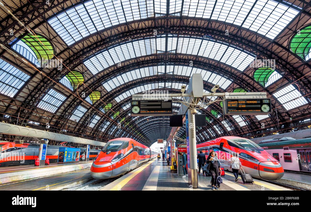 Milan, Italy - May 17, 2017: Modern high-speed trains at the railway Milan Central Station. Industrial landmark and tourist place of Milan. Concept of Stock Photo
