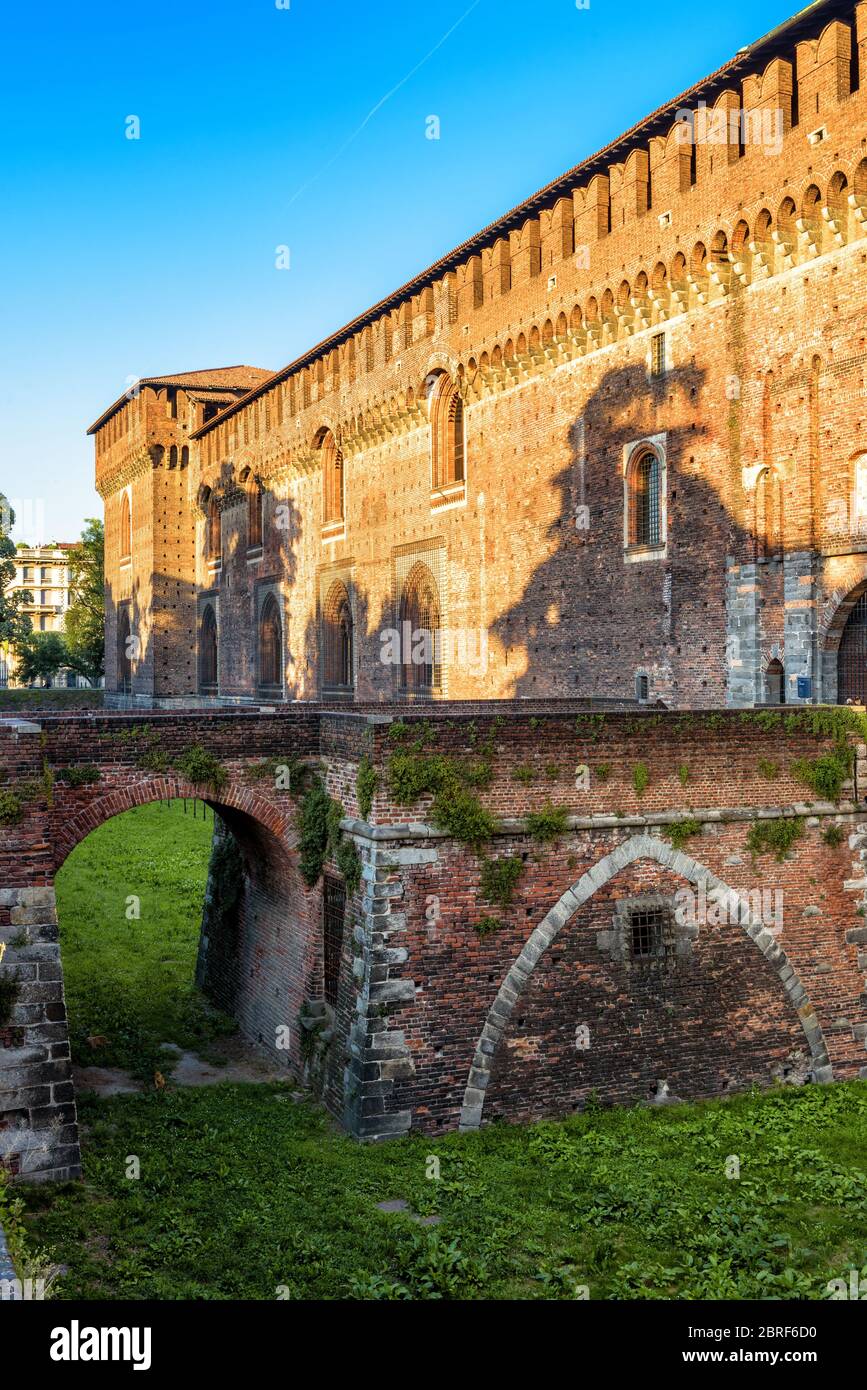 Sforza Castle with moat and bridge, Milan, Italy. It was built in 15th century by Francesco Sforza, Duke of Milan. Historical architecture and landmar Stock Photo