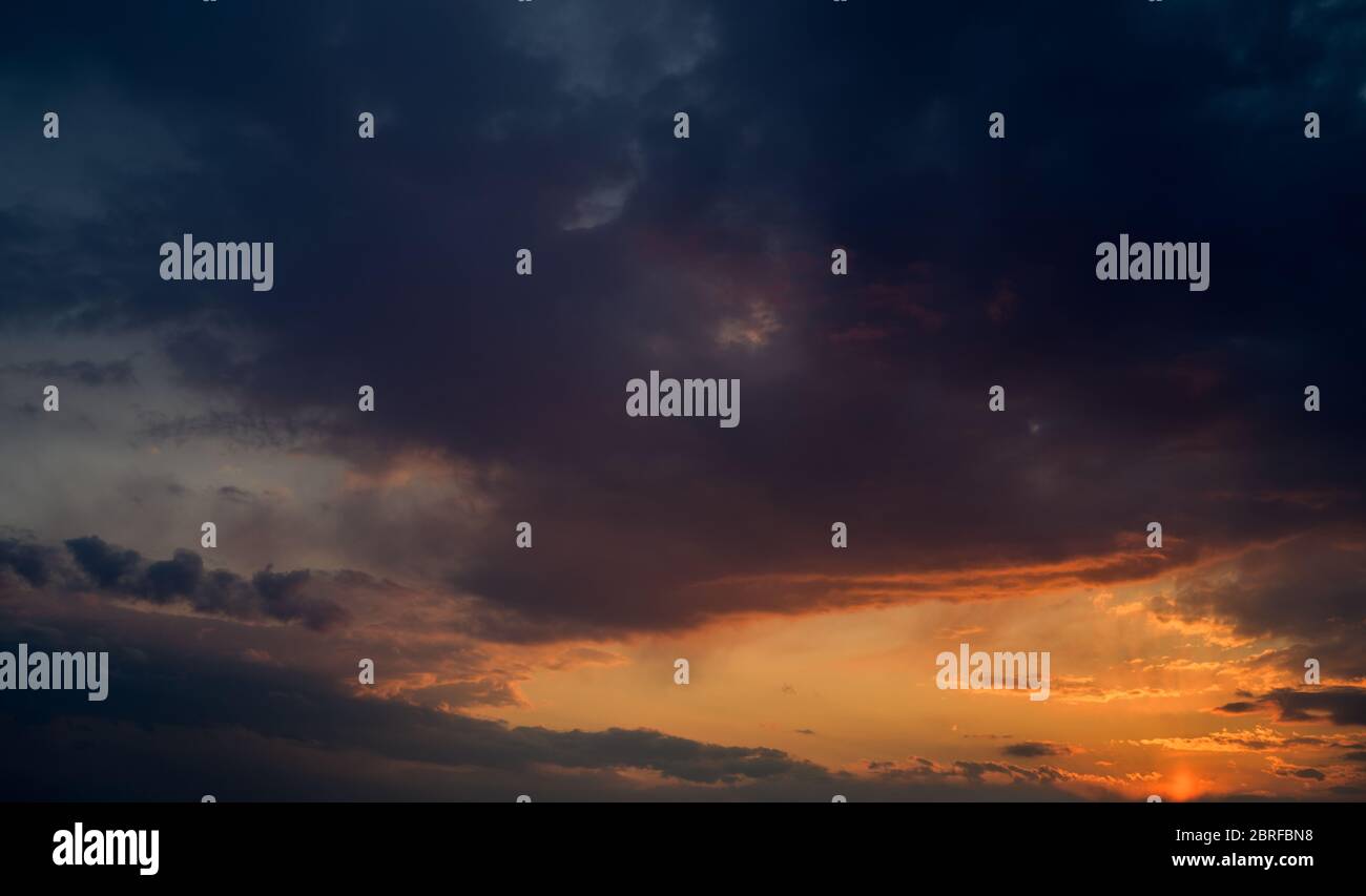 Dramatic sunset sky with orange colored clouds Stock Photo - Alamy