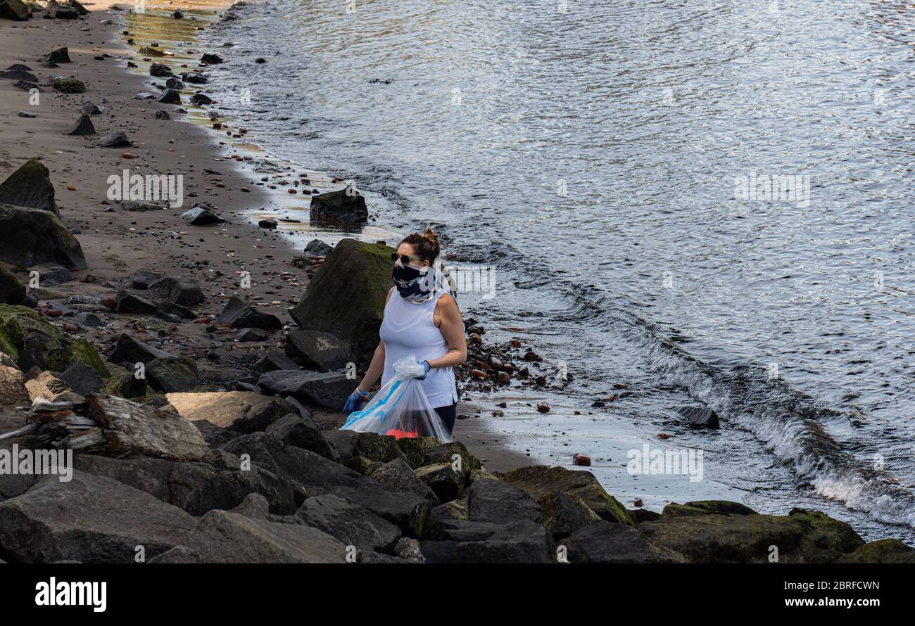 DUMBO, Brooklyn, New York, May 22, 2020 volunteer cleaning shores