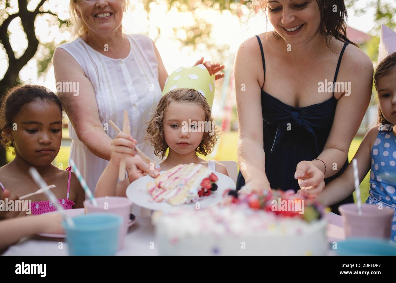Kids birthday party outdoors in garden in summer, celebration concept. Stock Photo