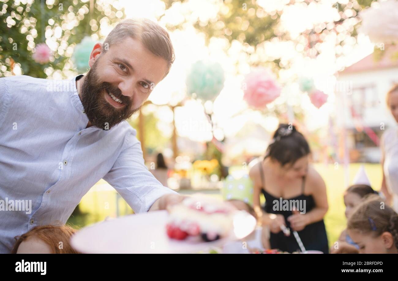 Birthday party outdoors in garden in summer, celebration concept. Stock Photo