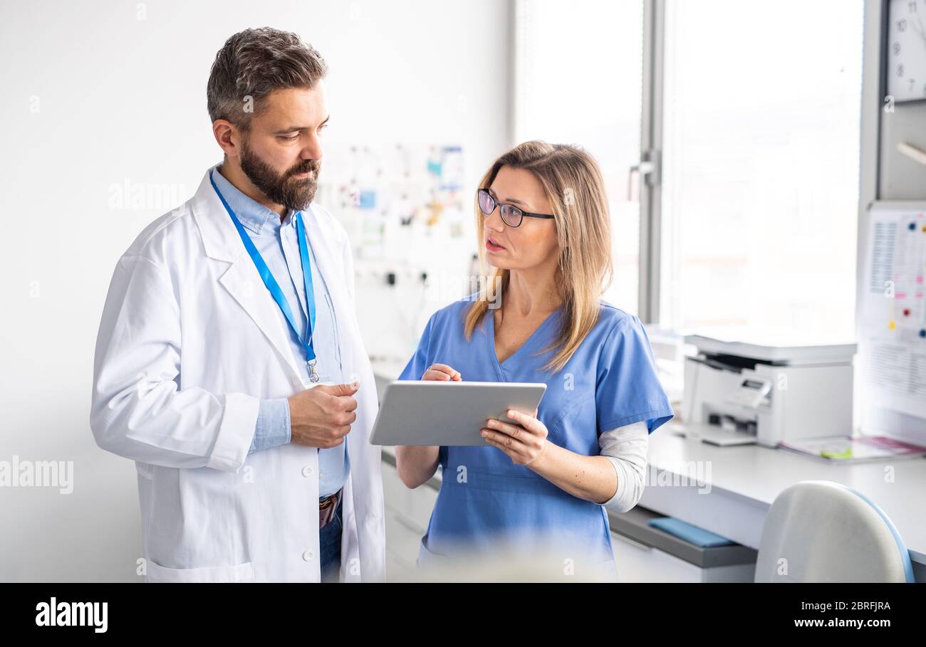 A dentist with dental assistant in modern dental surgery, working Stock