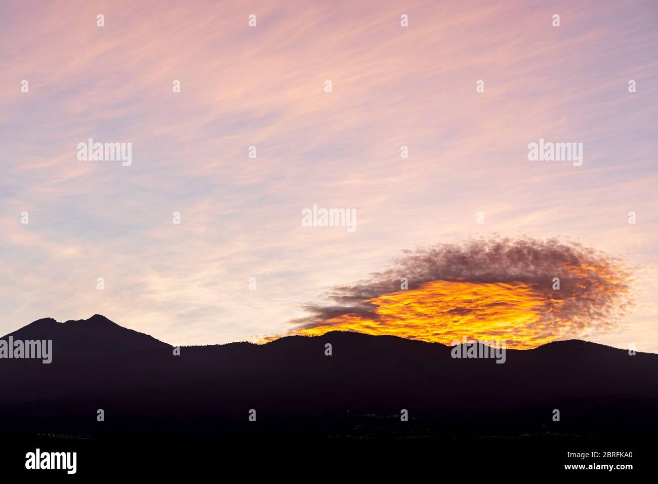 Pre dawn light in the sky over Teide volcano with some unusual clouds, Tenerife, Canary Islands, Spain Stock Photo