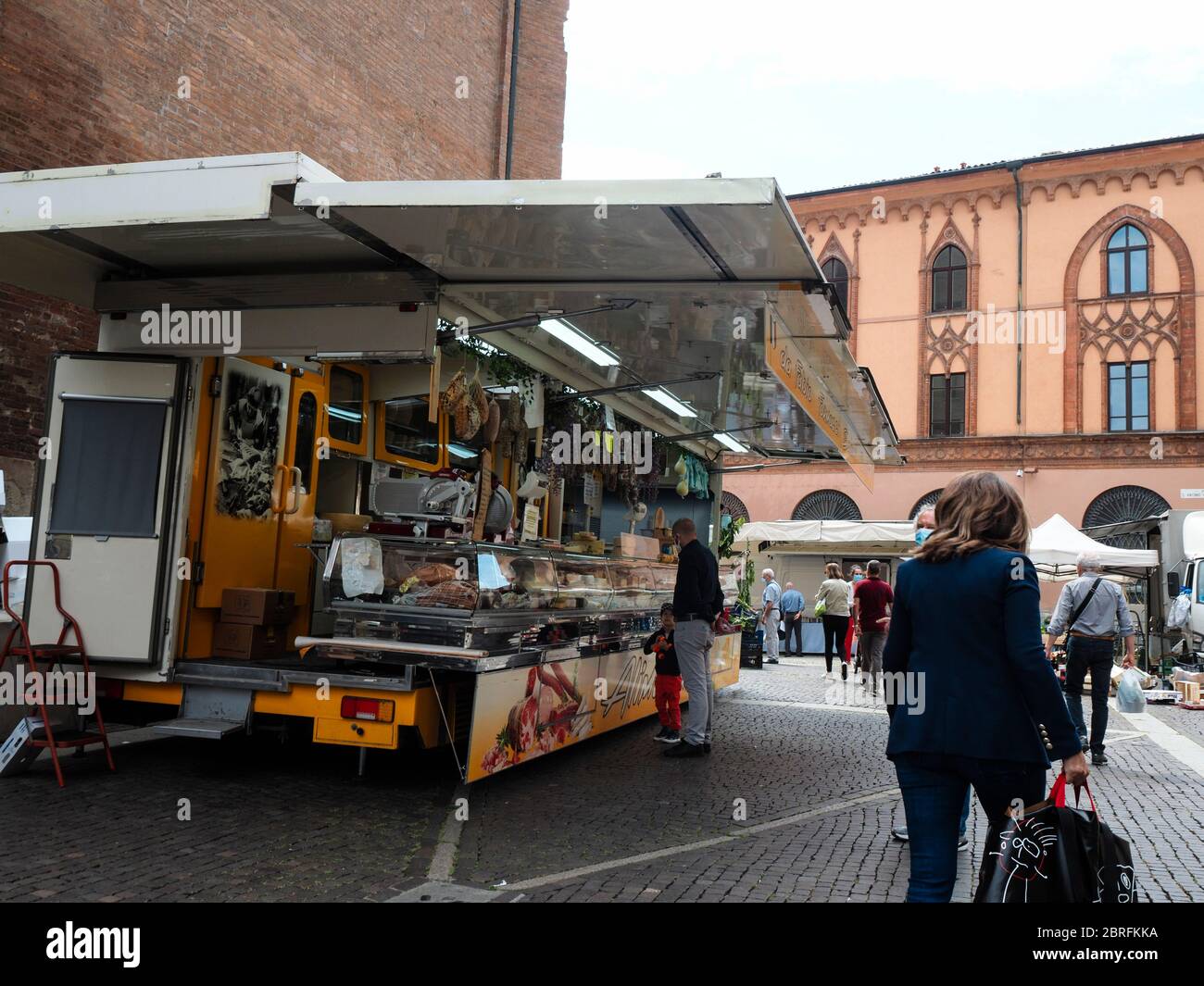 Cremona, Italy People grocery shopping in open air food market with