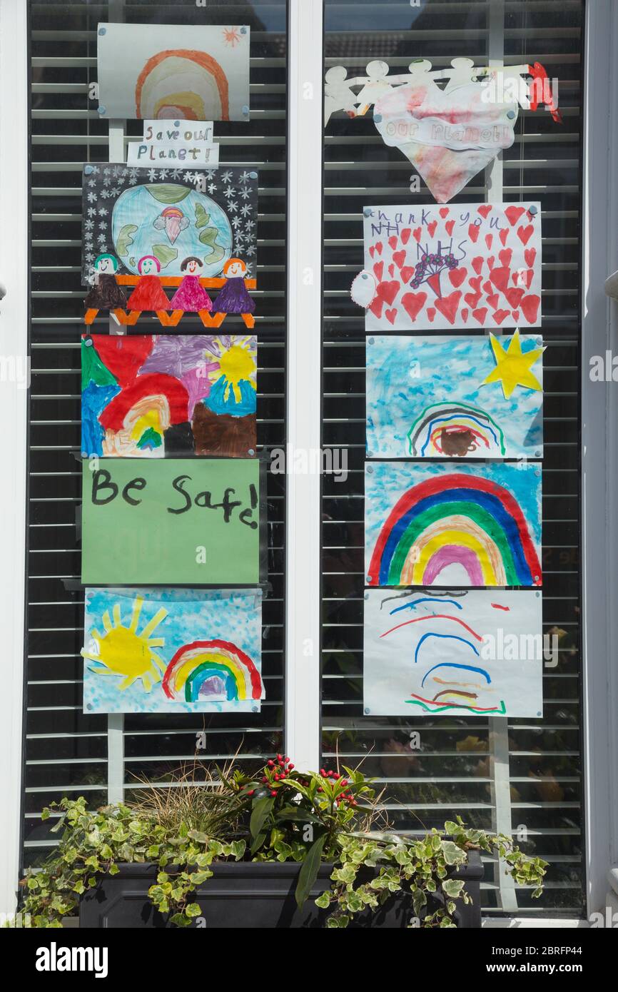 Pictures of rainbows by children displayed in window of home to thank ...