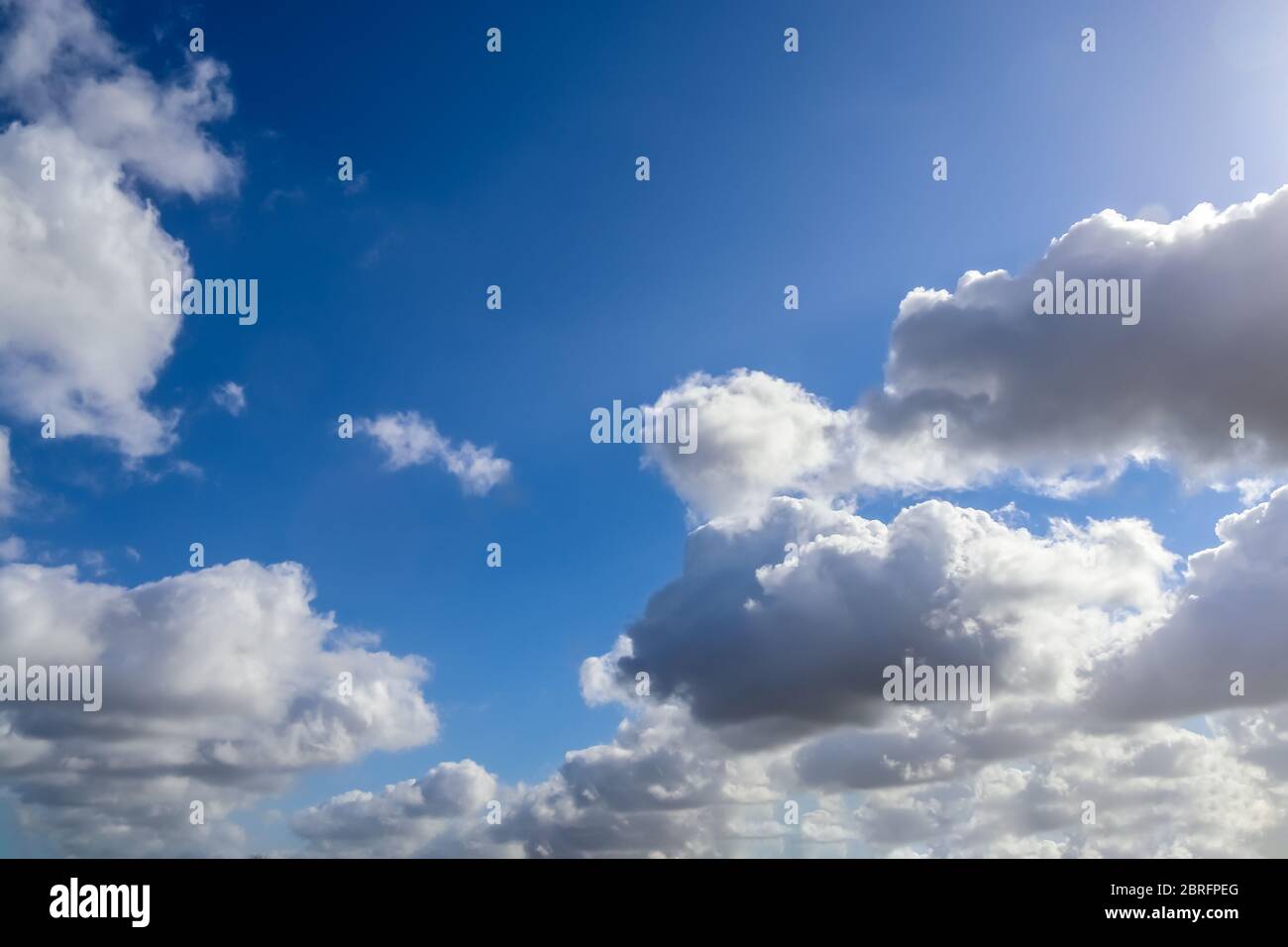 Beautiful white fluffy clouds in a deep blue summer sky Stock Photo - Alamy