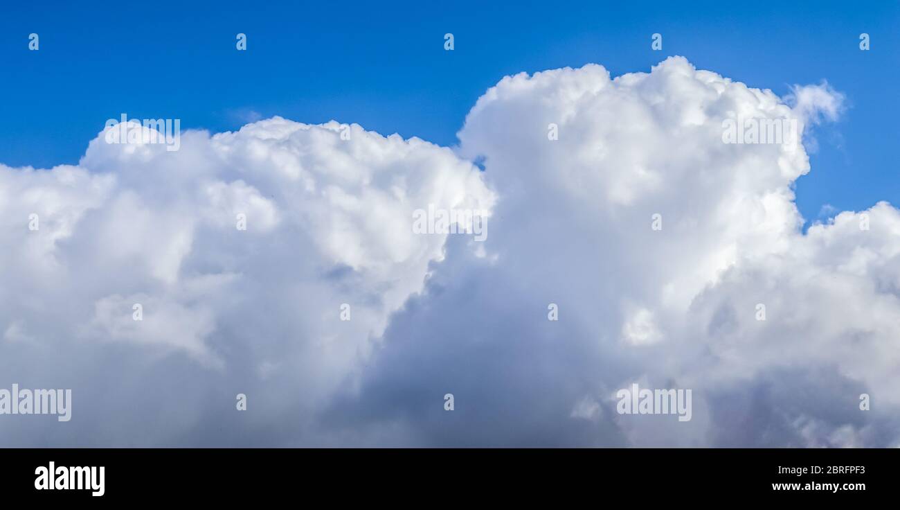 Beautiful white fluffy clouds in a deep blue summer sky Stock Photo - Alamy