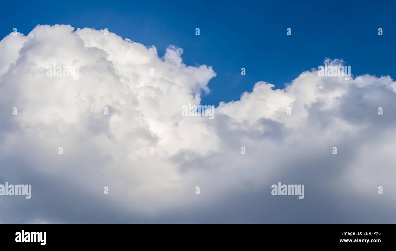 Beautiful white fluffy clouds in a deep blue summer sky Stock Photo - Alamy