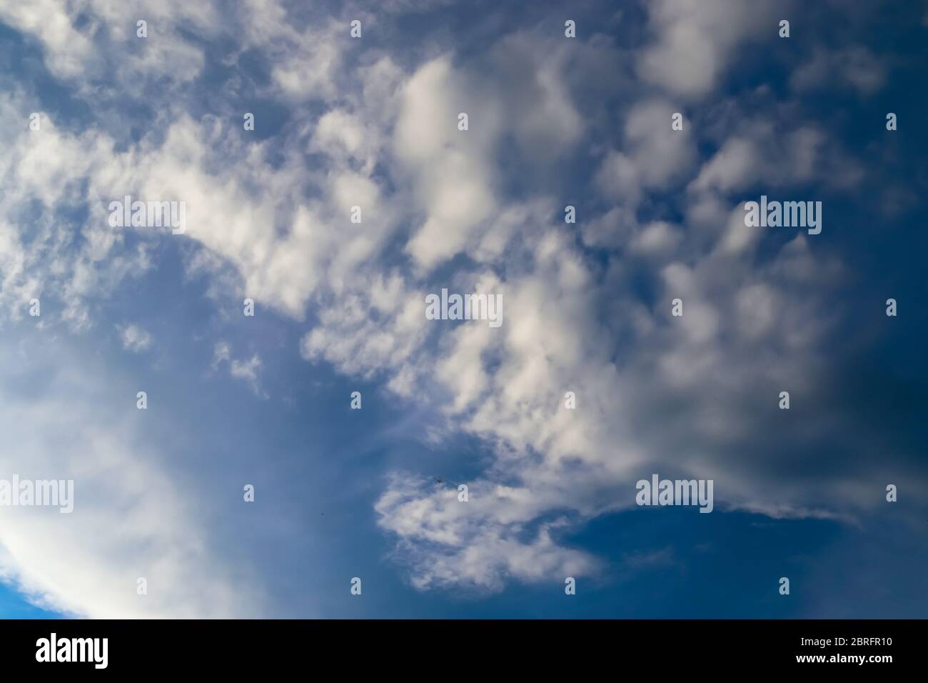 Beautiful white fluffy clouds in a deep blue summer sky Stock Photo - Alamy