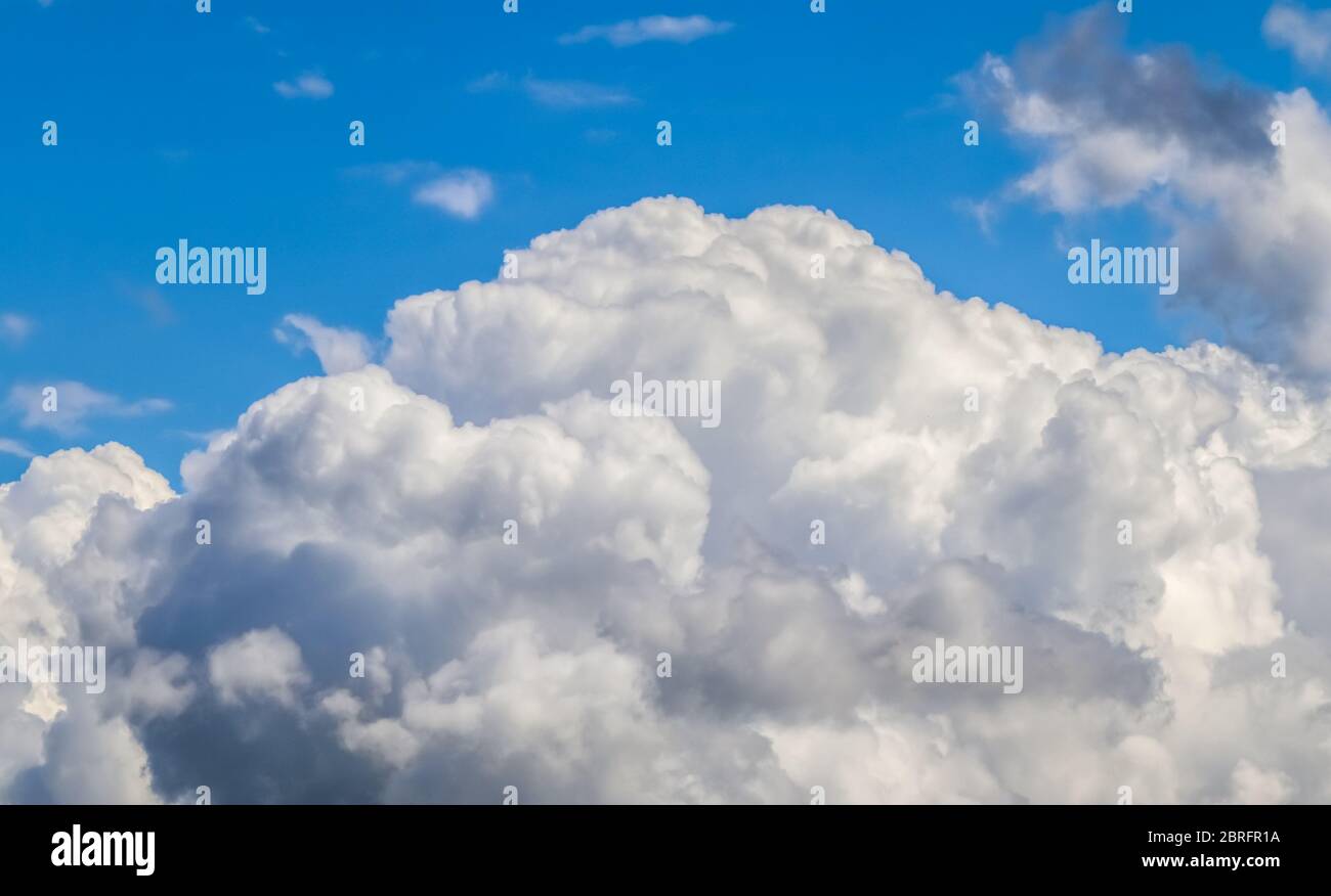 Beautiful white fluffy clouds in a deep blue summer sky Stock Photo - Alamy