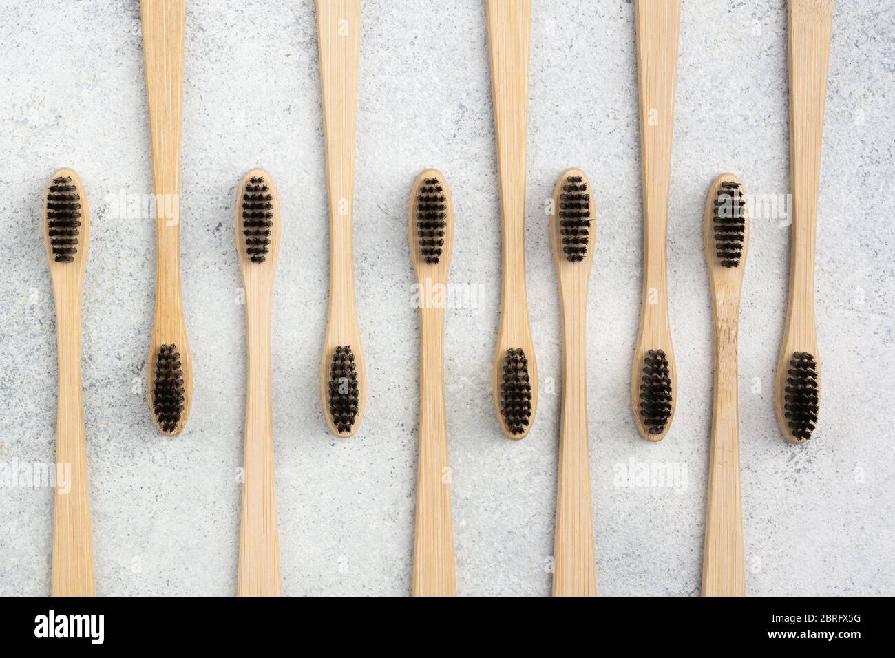 Zero waste eco friendly bamboo toothbrushes on white table, top view, selective focus Stock Photo