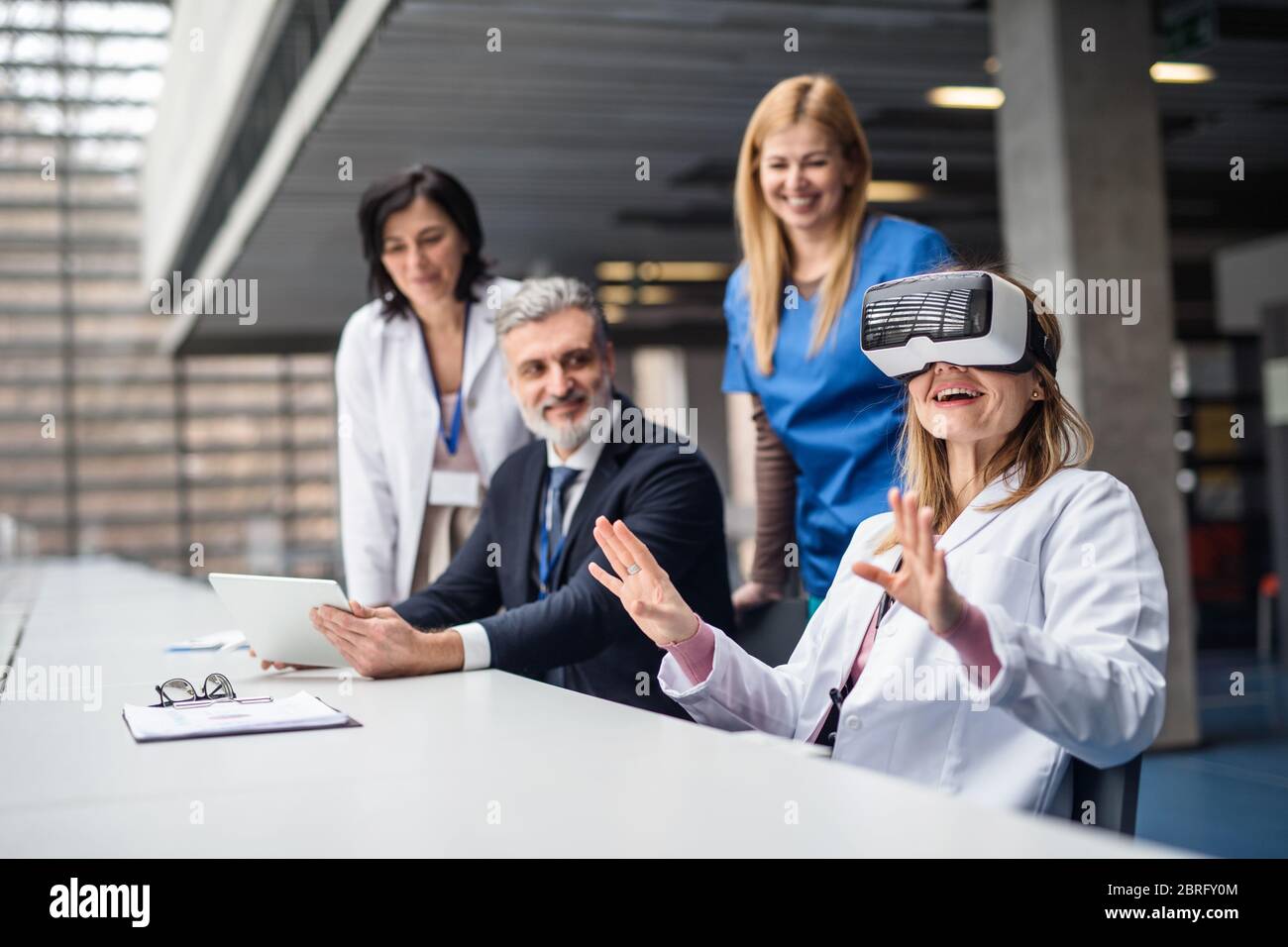 Doctors and pharmaceutical sales representative using VR goggles. Stock Photo