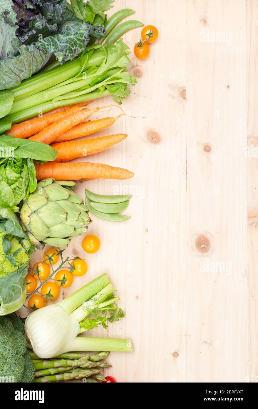 Top view of vegetables on wooden table, carrots celery tomatoes cabbage broccoli, copy space, selective focus Stock Photo