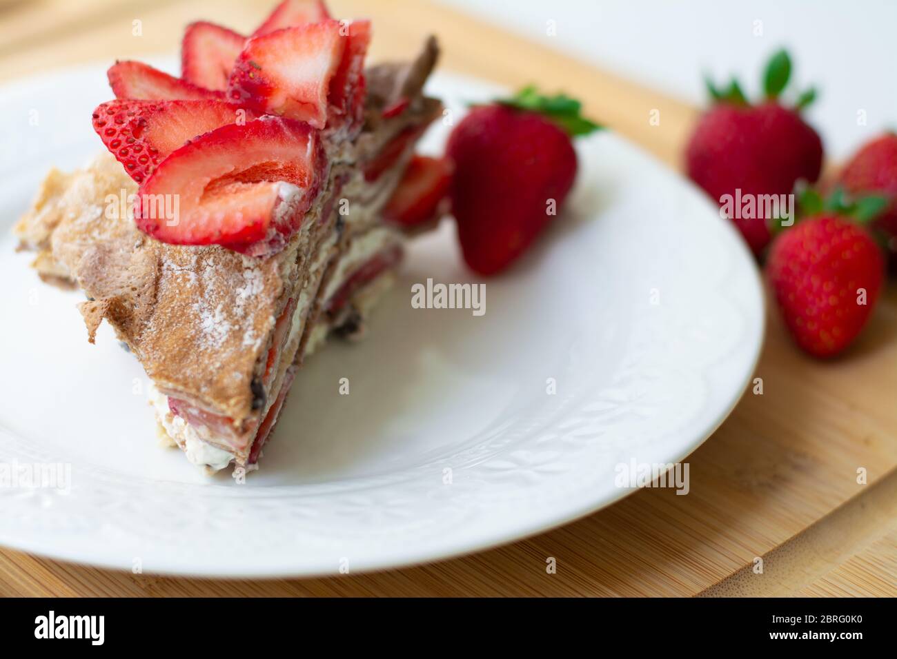 Light summer dessert a slice of crepe layer cake with whipped cream