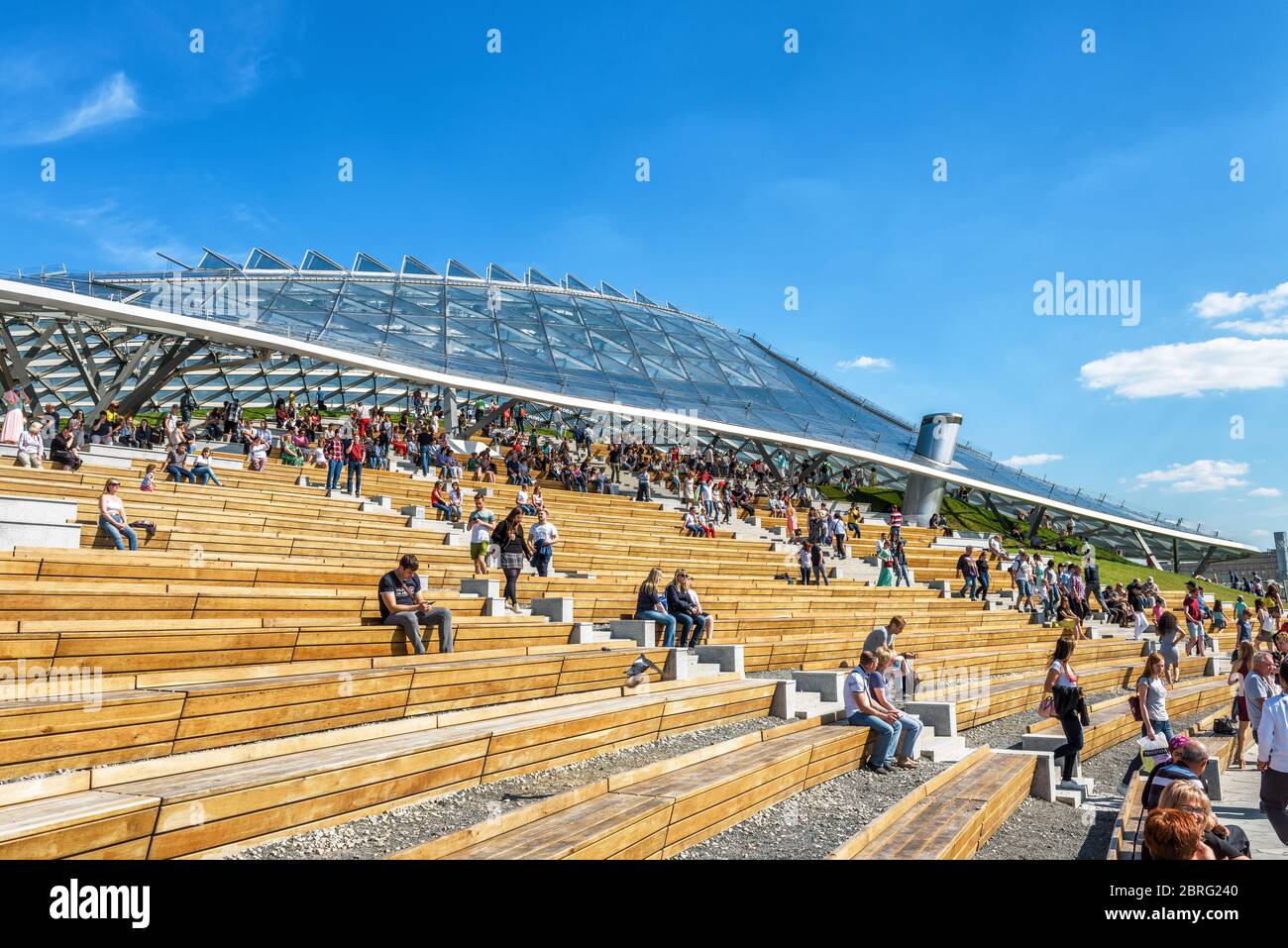 Moscow - June 16, 2018: People visit the modern amphitheater with a glass roof in Zaryadye Park in Moscow, Russia. Zaryadye is one of the main tourist Stock Photo