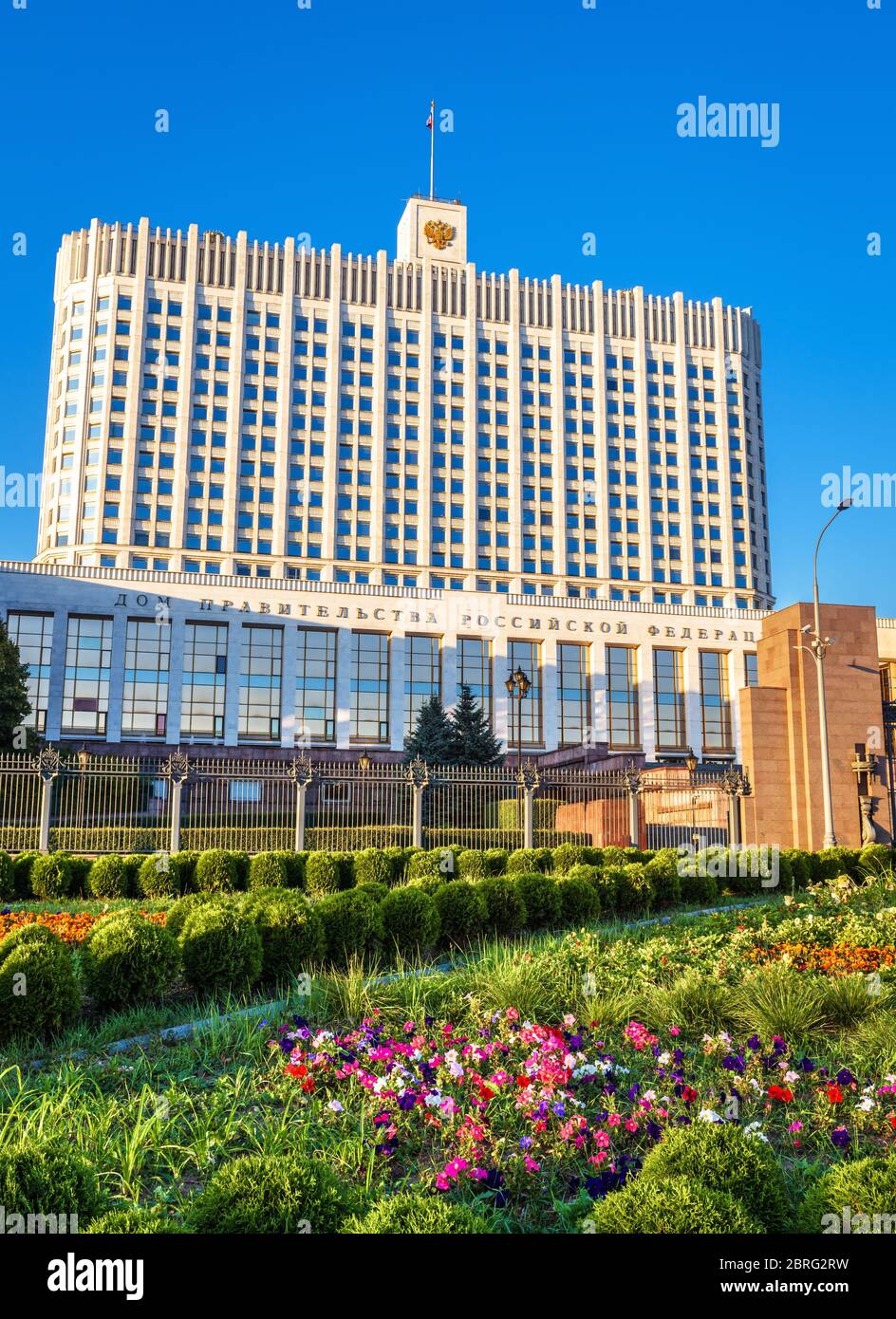 House of Government of Russian Federation (it is written on facade), Moscow. Scenic view of White House and flower garden in the Moscow center. Vertic Stock Photo