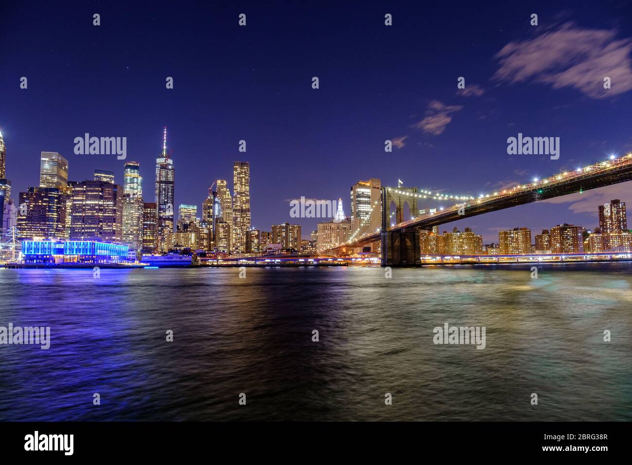 A long exposure of the Brooklyn Bridge and Manhattan skyline at Night, New York, USA Stock Photo