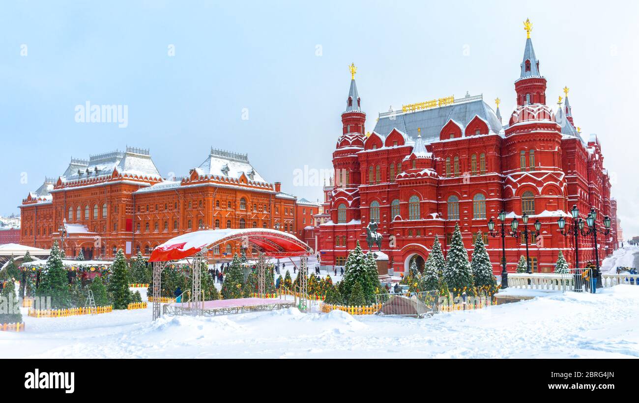 Moscow in cold winter, Russia. Panorama of the Manezhnaya Square during snowfall. Scenery of snowy Christmas trees in the Moscow city center. Frosty v Stock Photo