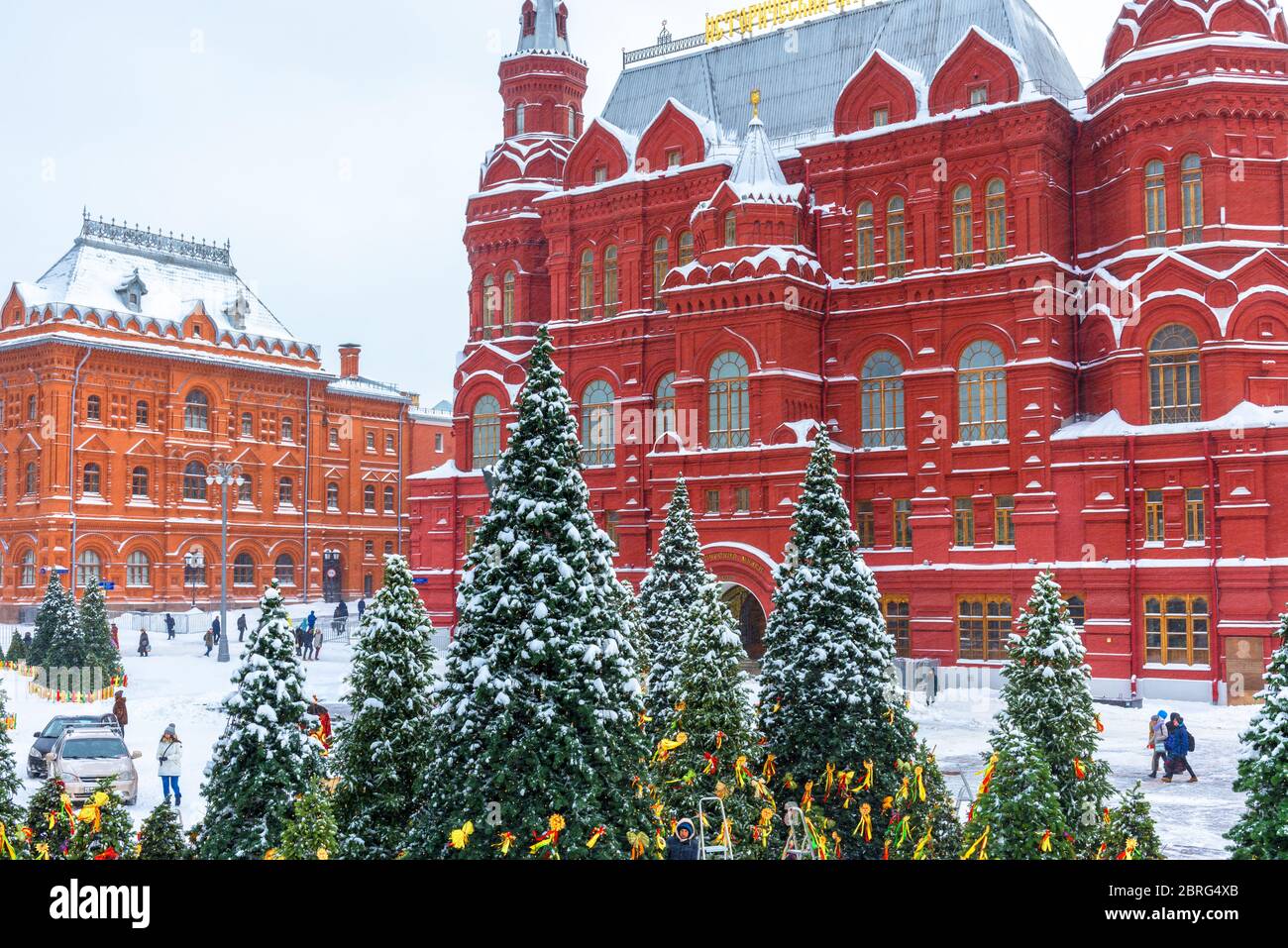 Moscow, Russia - Feb 5, 2018: Snowy Moscow center in winter. Christmas trees overlooking the State Historical Museum during snowfall. Old nice archite Stock Photo