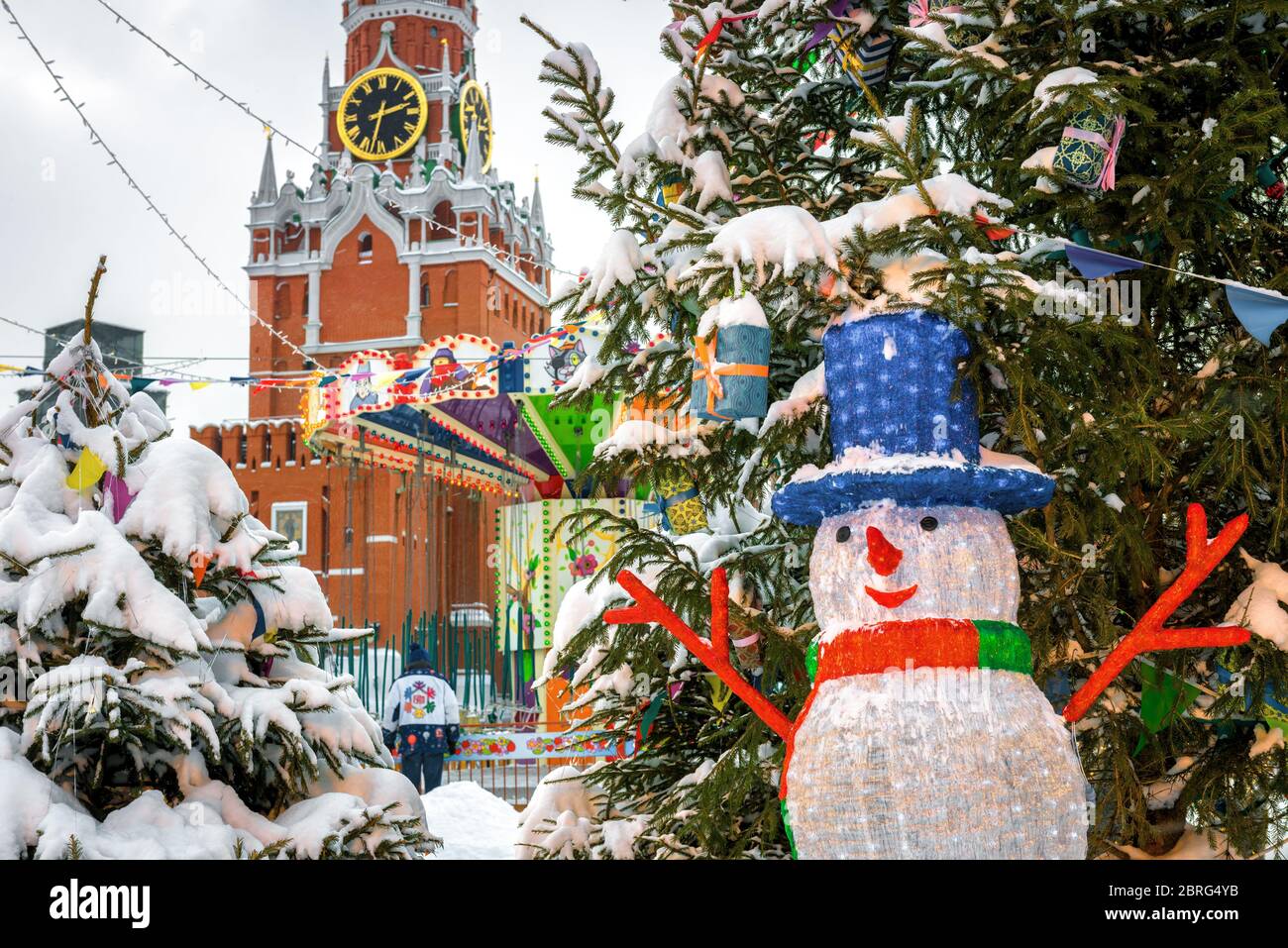 Moscow, Russia - February 5, 2018: Christmas decorations near Moscow Kremlin in winter. Central Moscow during snowfall. Snowman by the fir on the fest Stock Photo
