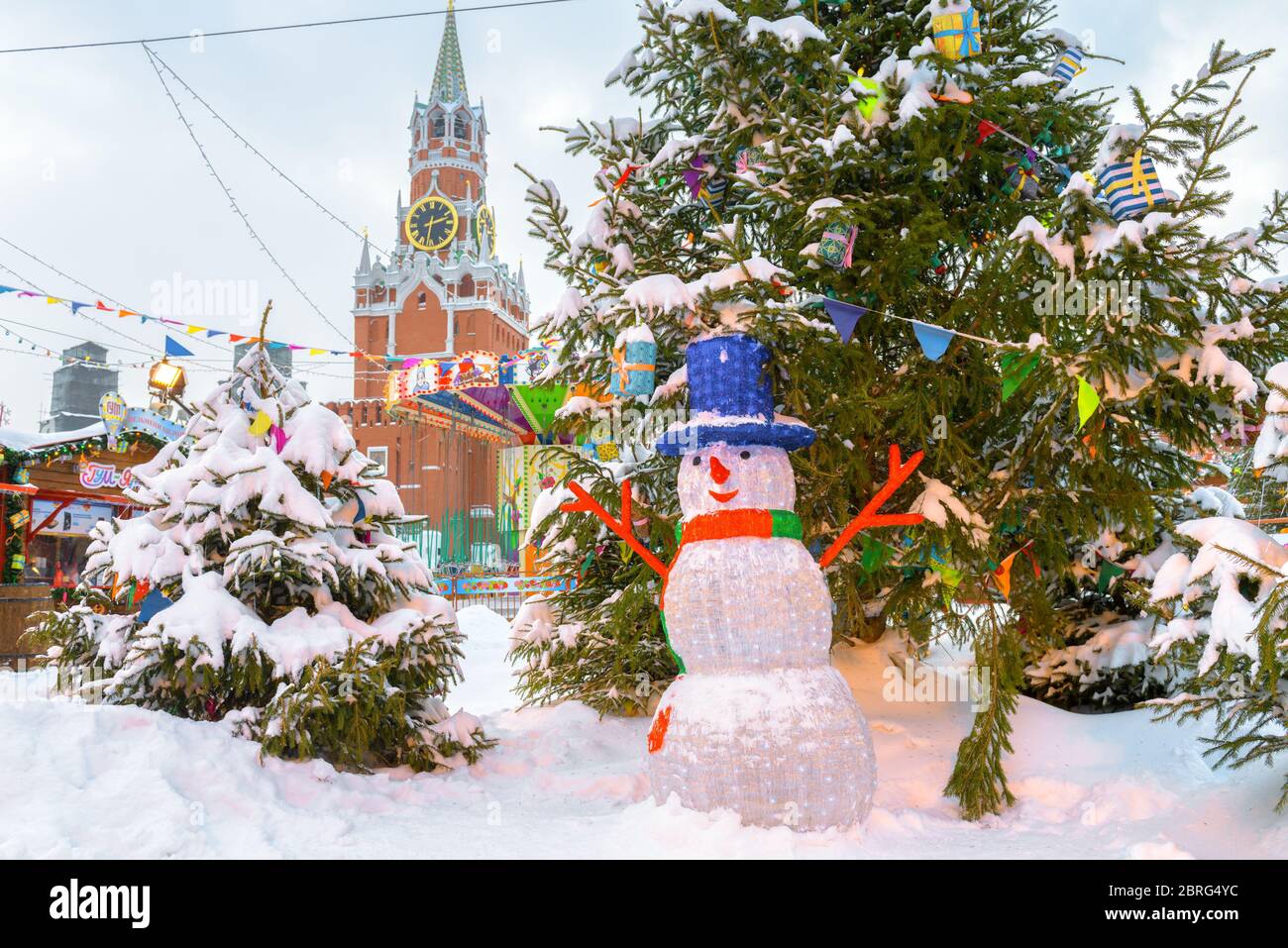 Moscow, Russia - Feb 5, 2018: Christmas decorations near Moscow Kremlin in winter. Snowman by the Christmas tree on the festive Red Square. Central Mo Stock Photo