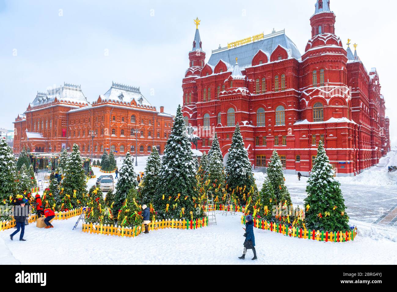 Moscow, Russia - Feb 5, 2018: Snowy Moscow center in winter. Christmas trees on the Manezhnaya square during snowfall. Nice vintage architecture of Mo Stock Photo