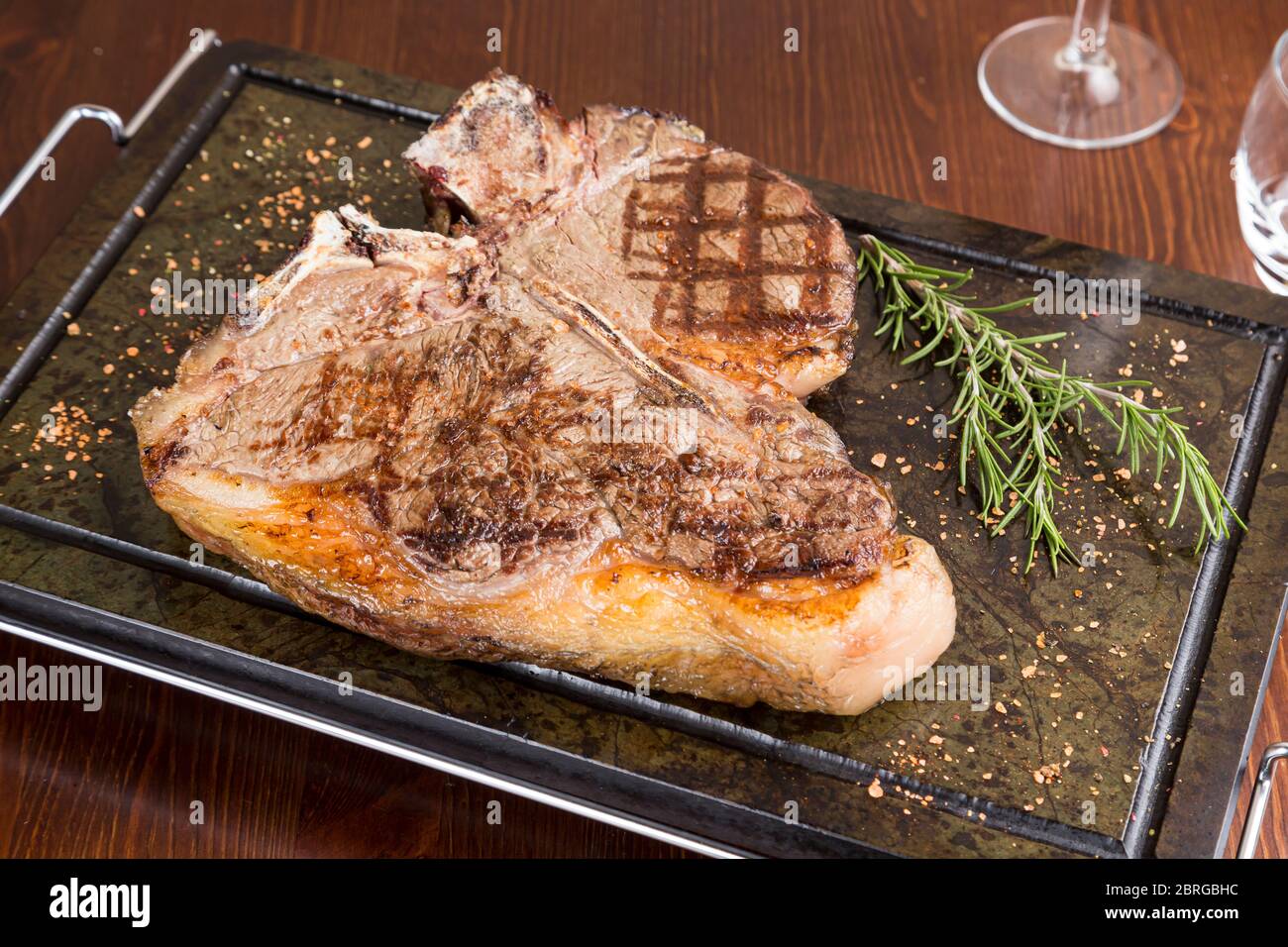 t-bone steak on soapstone with rosemary Stock Photo - Alamy
