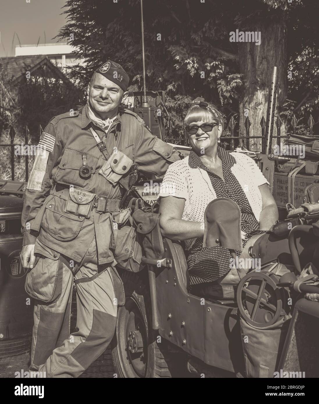 Severn Valley Railway 1940s summer event. 1940s man in US army uniform and 1940s woman sitting in Willy's jeep. Stock Photo