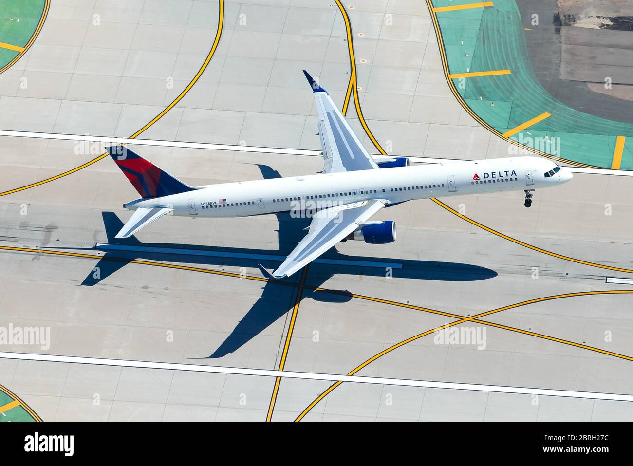 Delta Airlines Boeing 757 departing LAX International Airport. Aerial view of aircraft take off with airport taxiway lines. Domestic air travel in USA Stock Photo