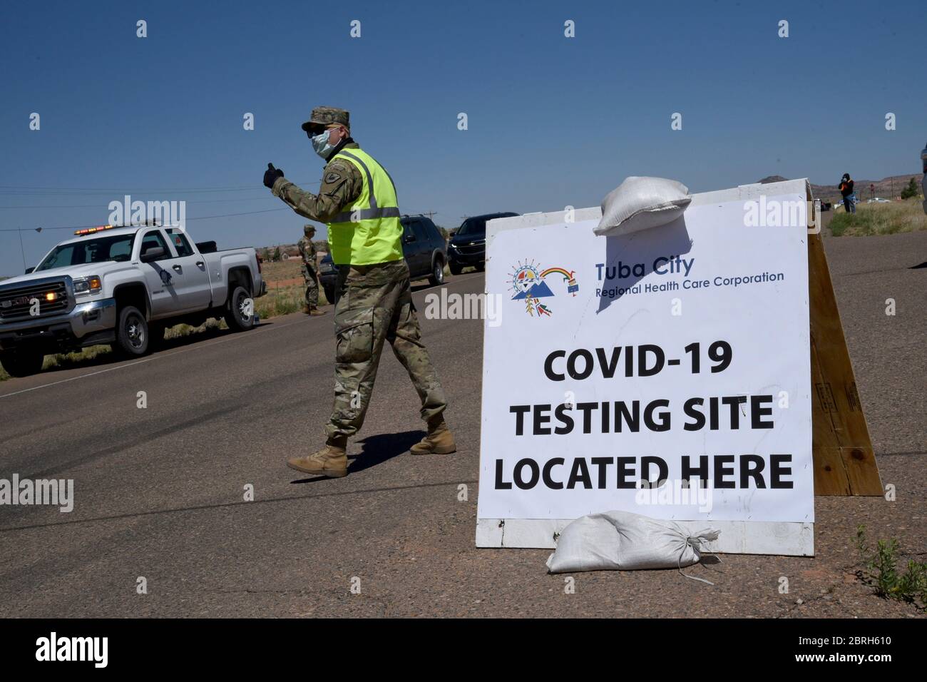Arizona National Guard soldiers directs traffic at a drive thru Coronavirus testing site on the Navajo Nation May 19, 2020 in Tonalea, Arizona. Stock Photo
