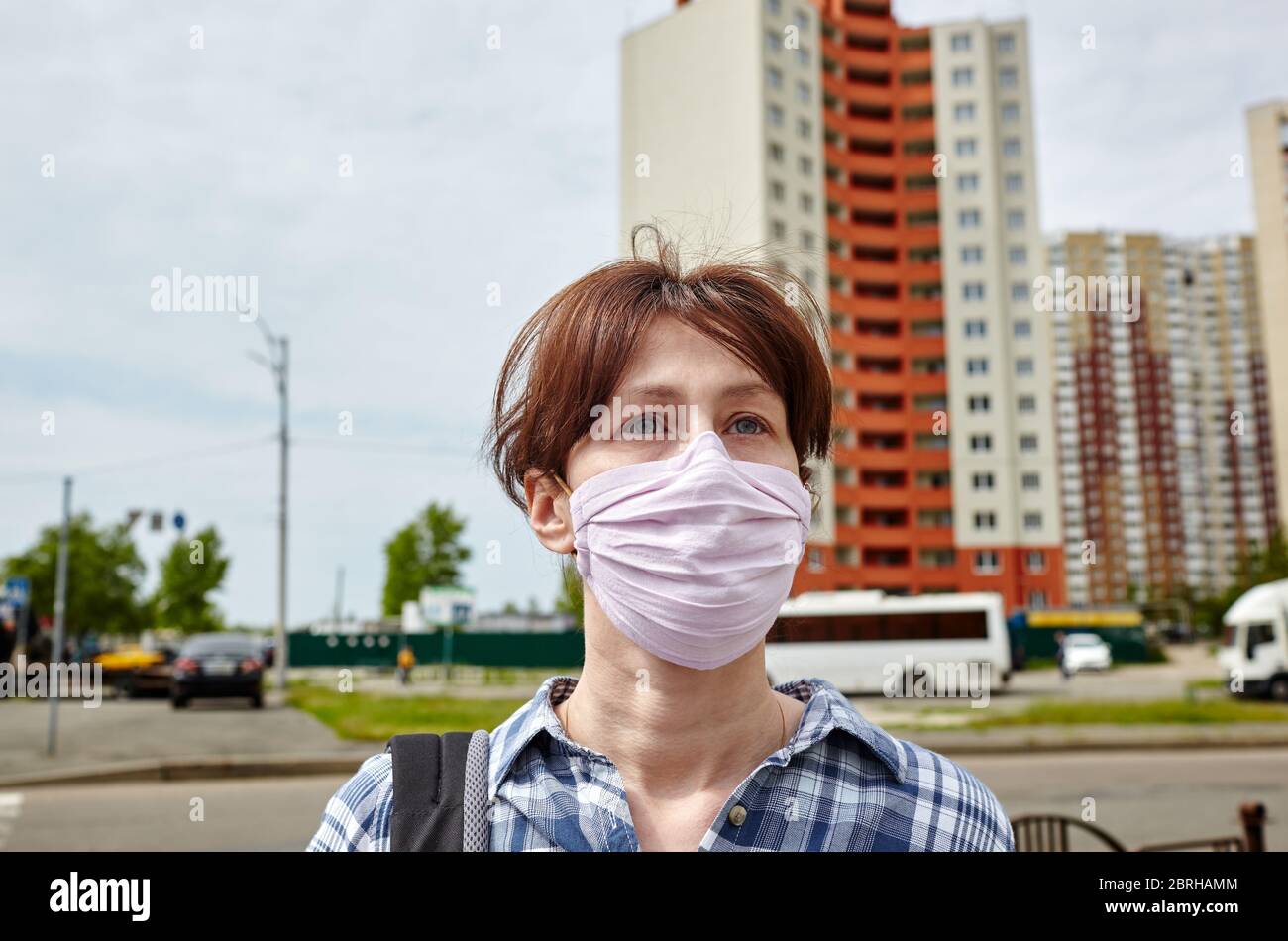 Woman wearing hygienic mask to prevent the Coronavirus. People in masks The outbreak of Novel Corona virus (2019-nCoV) in Europe. Stock Photo
